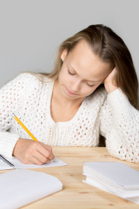 Schoolgirl doing difficult homework